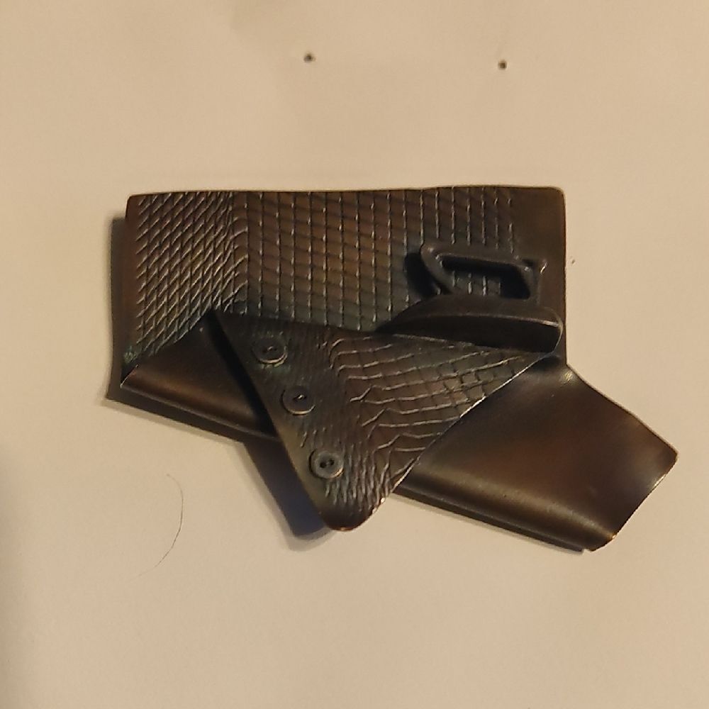 Copper Pin Of A Cloth With Buttons Being Ironed